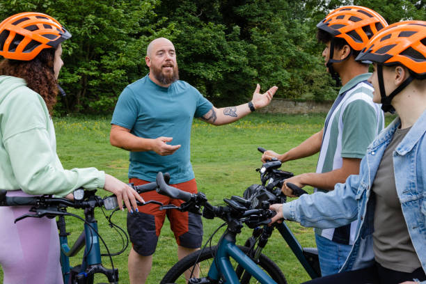Cycling instructor helping a beginner with technique